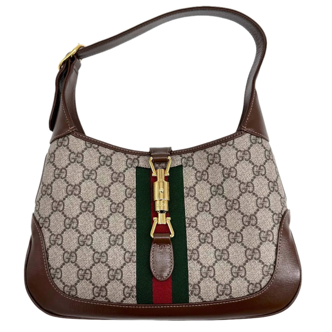 Gucci investment handbag featuring classic GG monogram, green and red stripe, and elegant leather accents.