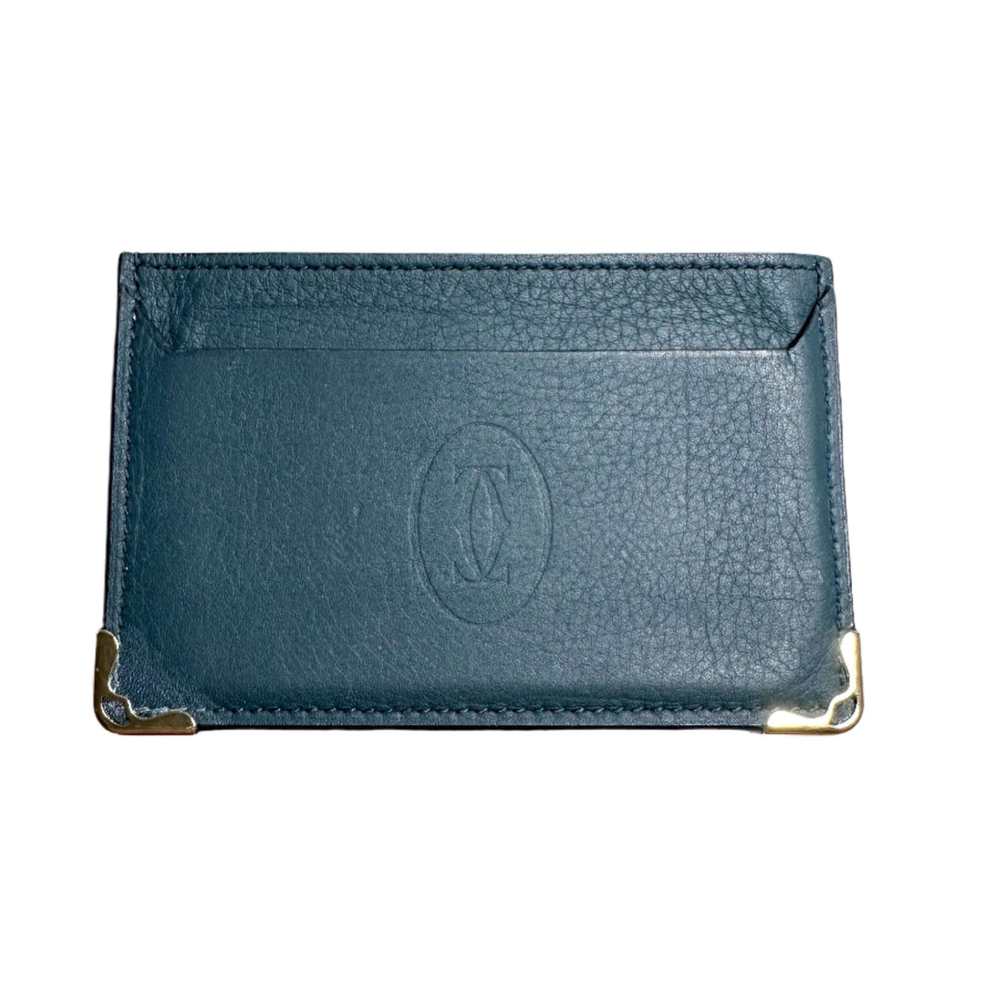 Luxurious Cartier blue calfskin card holder with signature logo imprint and elegant metal corner accents.