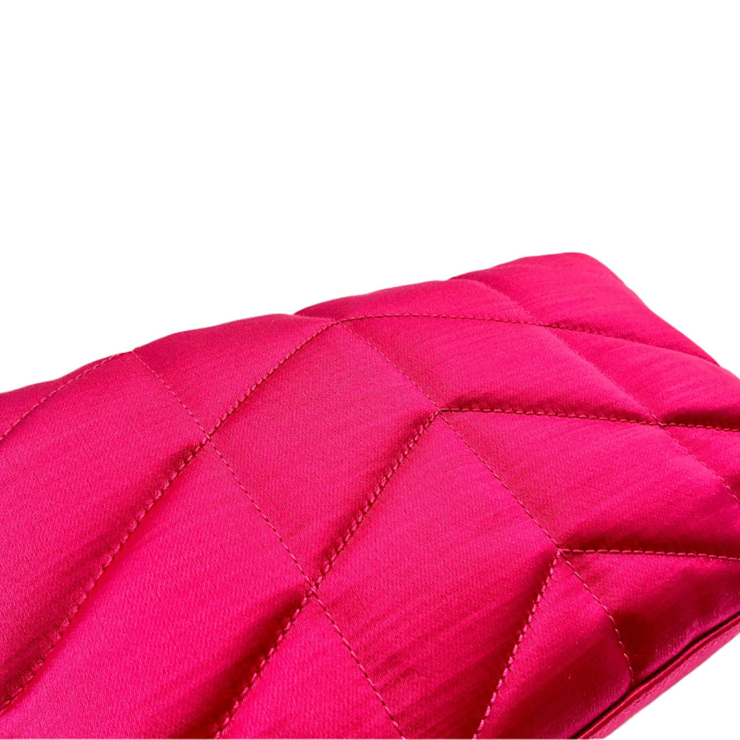 Vibrant pink quilted fabric with diamond stitching pattern.