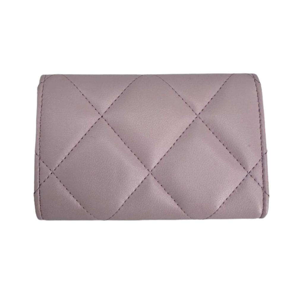 Pink Chanel goatskin quilted Chanel 19 flap wallet, showcasing the elegant diamond pattern from the back view.