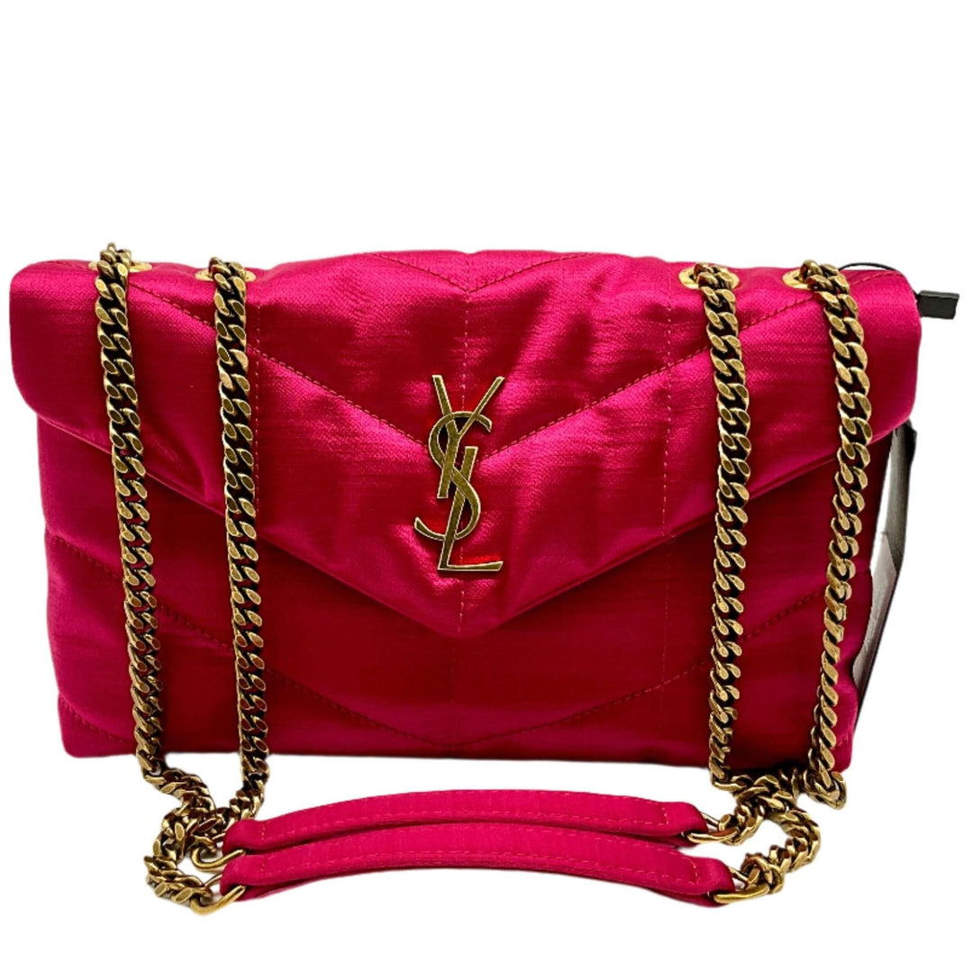 Vibrant pink YSL shoulder bag with gold chain straps and logo.