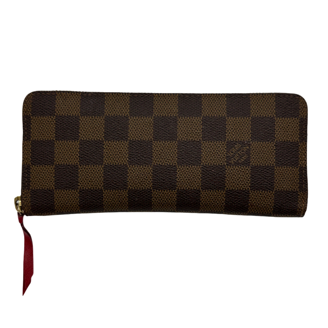 LOUIS VUITTON Damier Ebene Clemence Wallet in checkered brown and dark brown pattern with red zipper pull displayed front view.