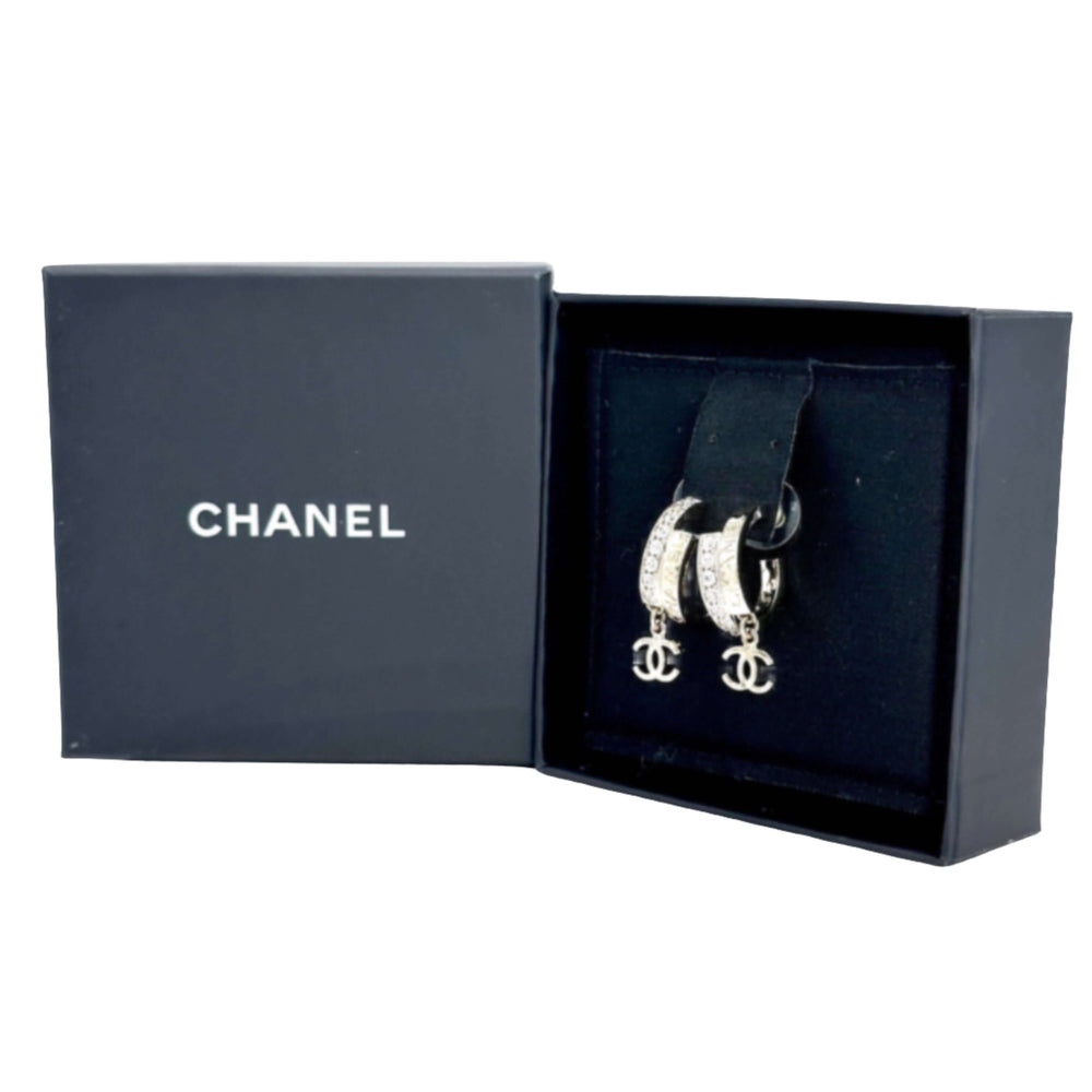 Chanel hoop earrings with signature logo in an open black Chanel box