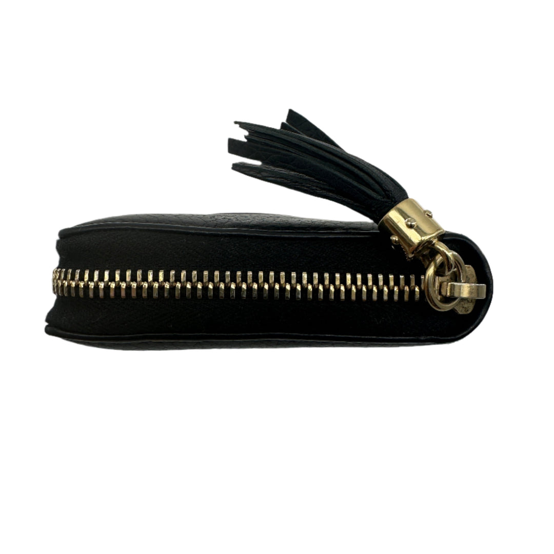 Side view of GUCCI Pebbled Calfskin Soho Zip Around Wallet in black with gold zipper and tassel detail.