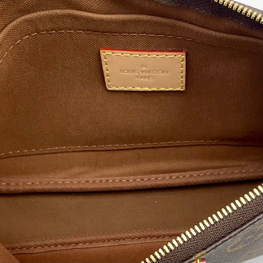 Inside view of LOUIS VUITTON Monogram Multi Pochette Large showcasing brown interior and Louis Vuitton label.