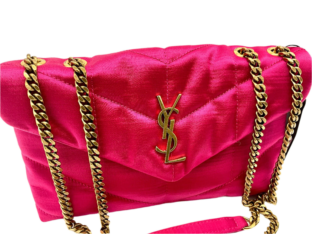 Luxurious pink YSL shoulder bag with gold chain strap and signature logo.