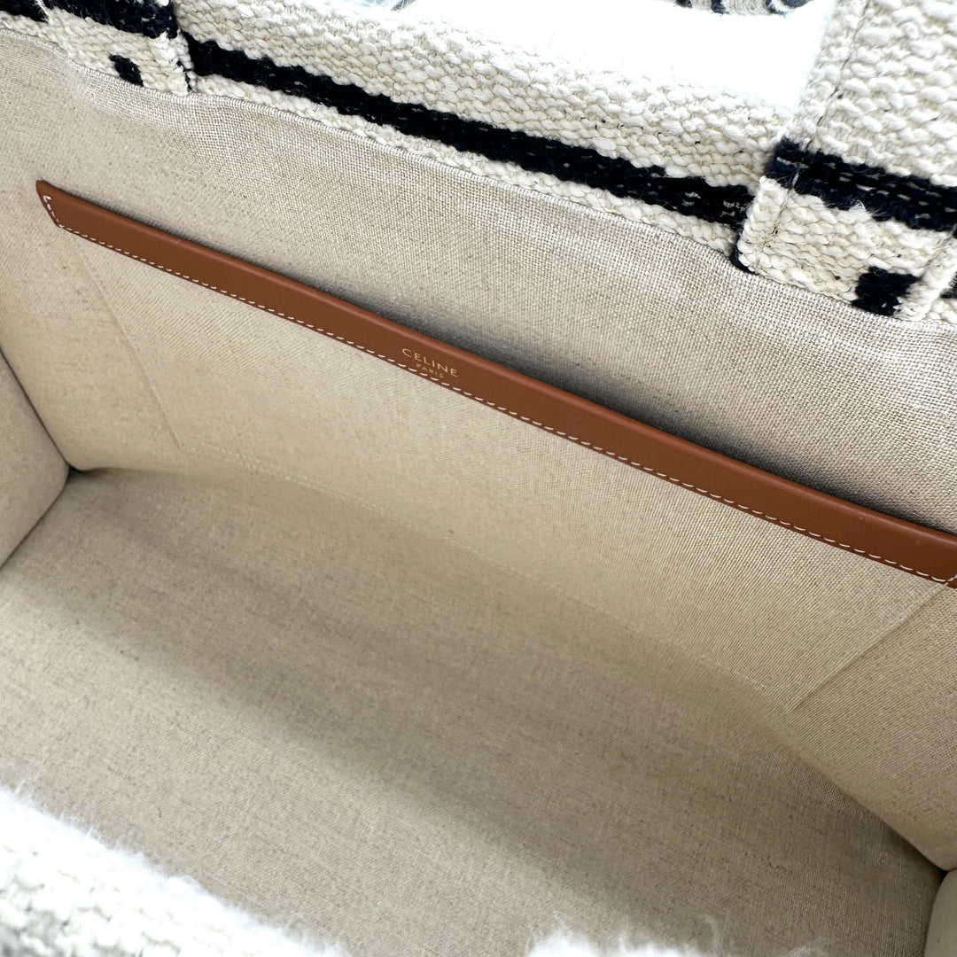 Interior view of CELINE Canvas Large All Over Cabas Thais bag showing beige fabric lining and an internal leather pocket