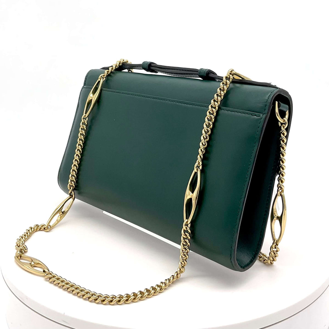 Gucci Zumi smooth leather small shoulder bag in green with gold chain strap on white background