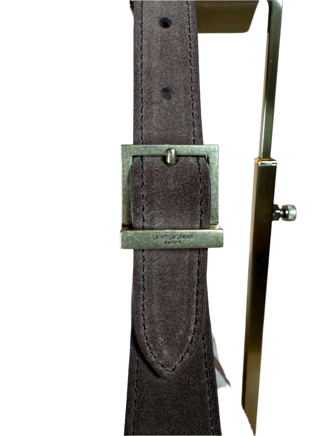 Close-up of a brown suede belt featuring a silver-tone buckle and elegant stitching details.