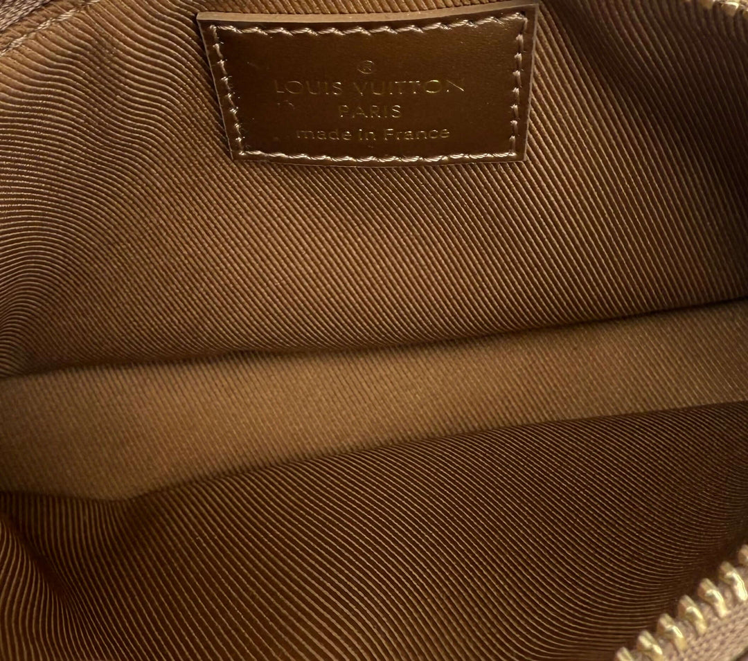 Interior view of authentic Louis Vuitton Louis Vuitton mini pochette, featuring embossed logo and smooth lining.