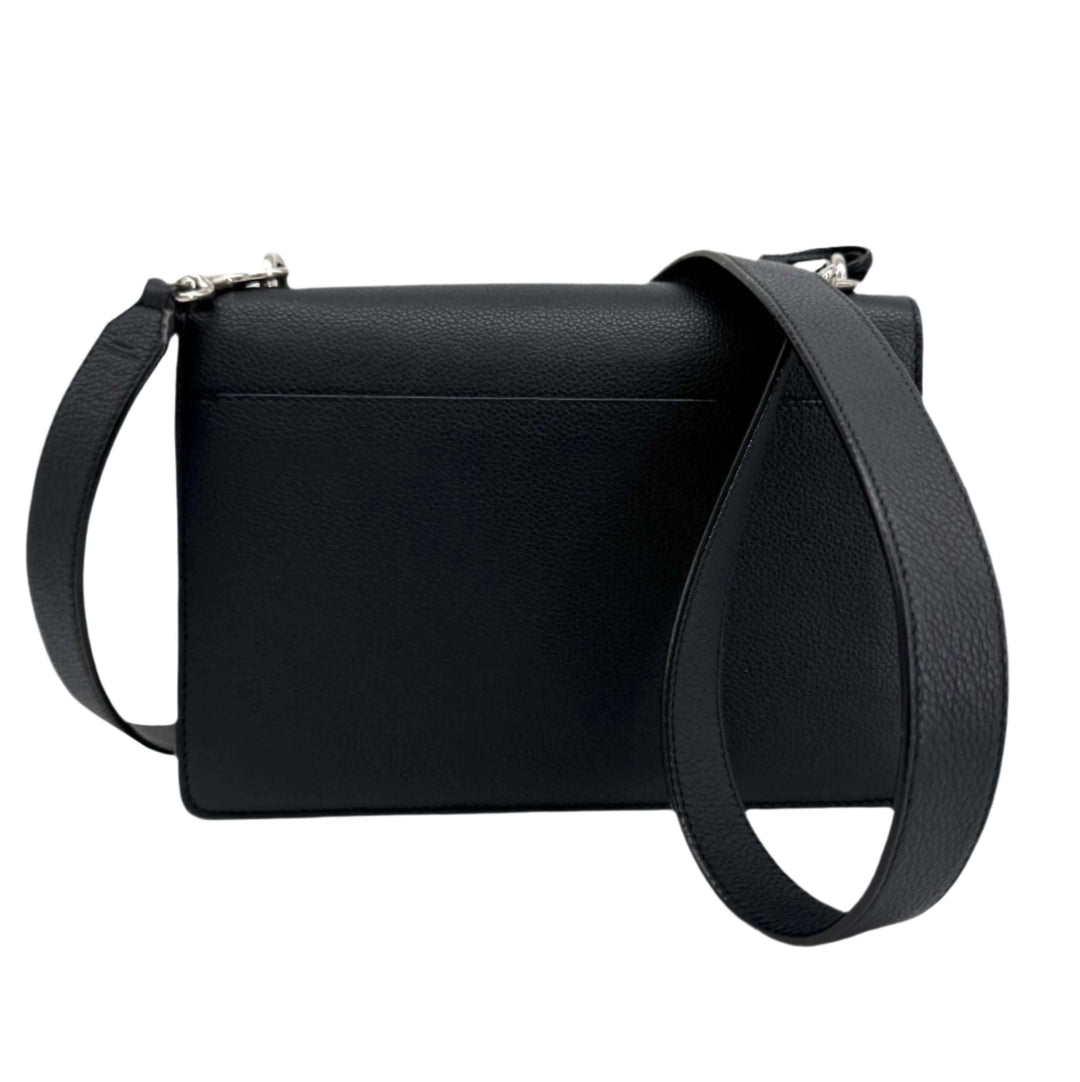 Authentic black calfskin bag with a structured design and adjustable strap, showcasing a sleek and modern silhouette.