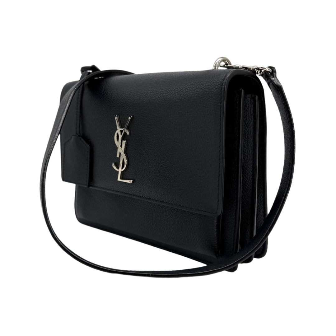 Authentic Saint Laurent Grained Calfskin Medium Monogram Sunset Bag in Navy Blue with YSL logo and chain strap.