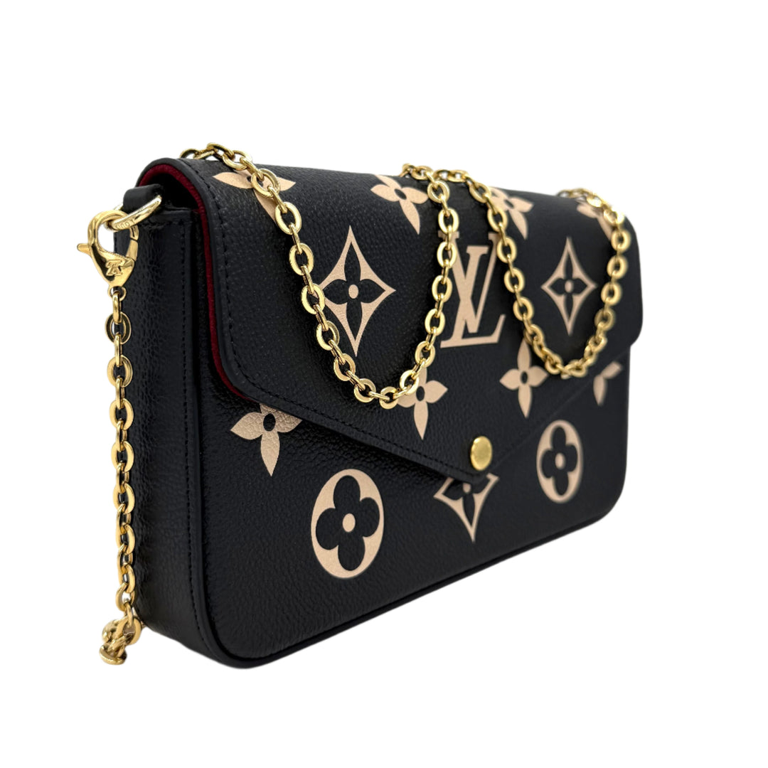 Authentic Louis Vuitton Empreinte Monogram Giant Felicie Pochette in black and beige with gold chain detail.