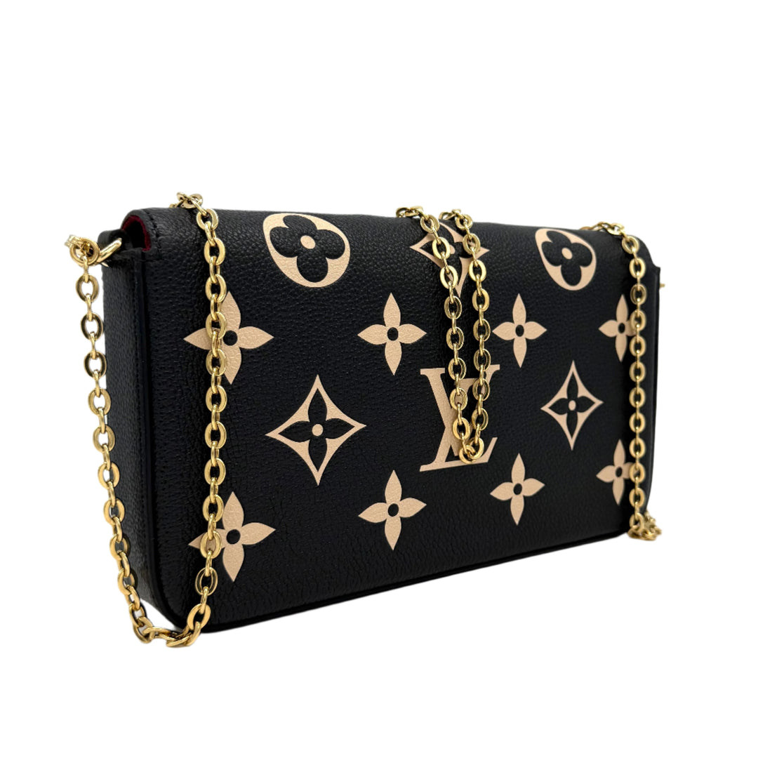 Authentic Louis Vuitton Empreinte Monogram Giant Felicie Pochette in Black and Beige with gold chain detail.