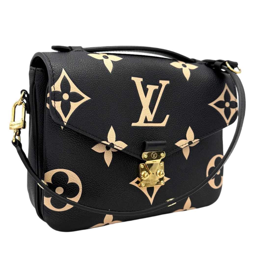 Authentic Louis Vuitton Empreinte Monogram Giant Pochette Metis in Black and Beige with oversized monogram and sleek design.