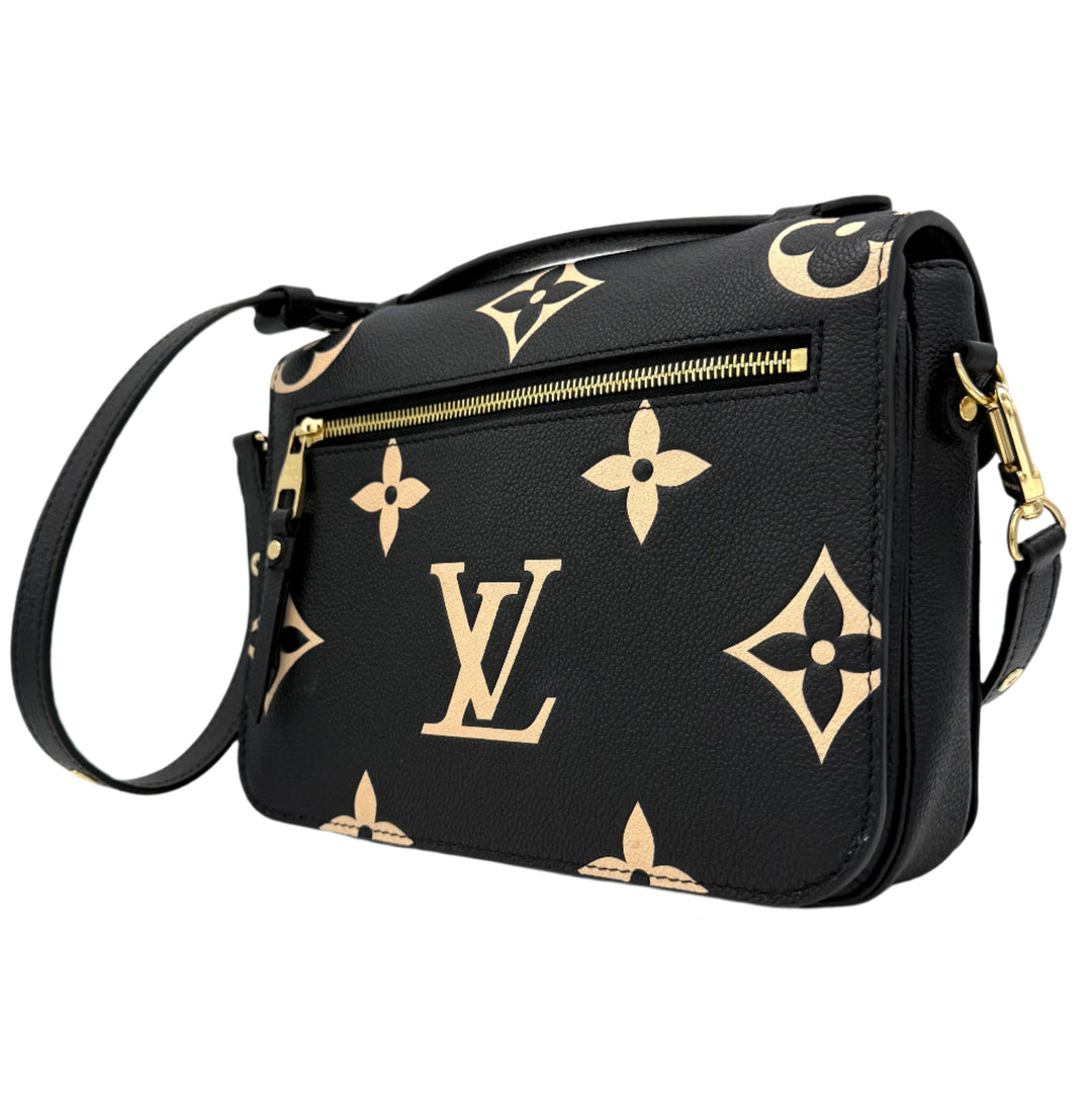 Authentic Louis Vuitton Empreinte Monogram Giant Pochette Metis in black and beige leather with oversized logo detailing.