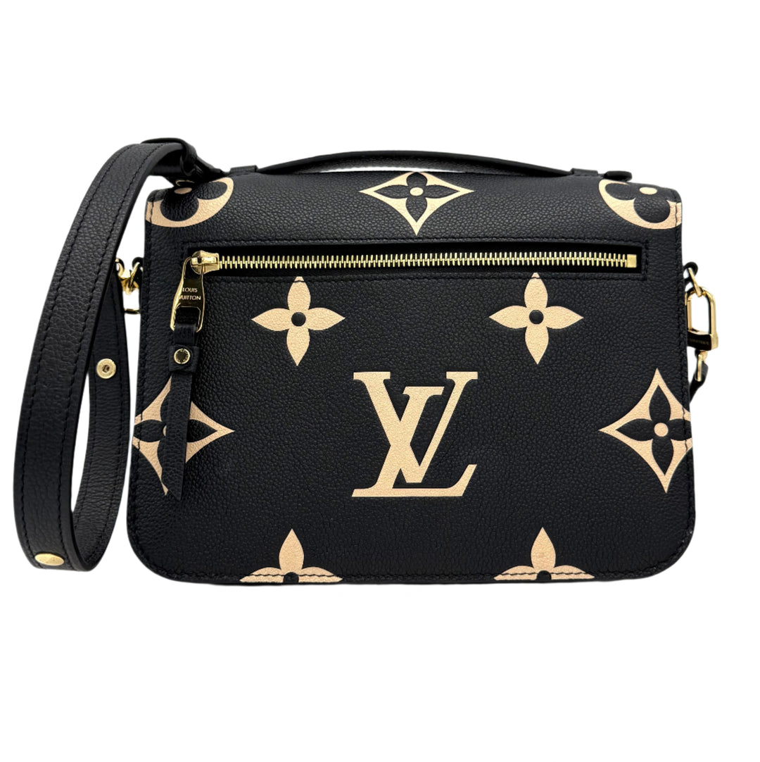 Authentic Louis Vuitton Empreinte Monogram Giant Pochette Metis in black and beige with luxurious oversized monogram detailing.