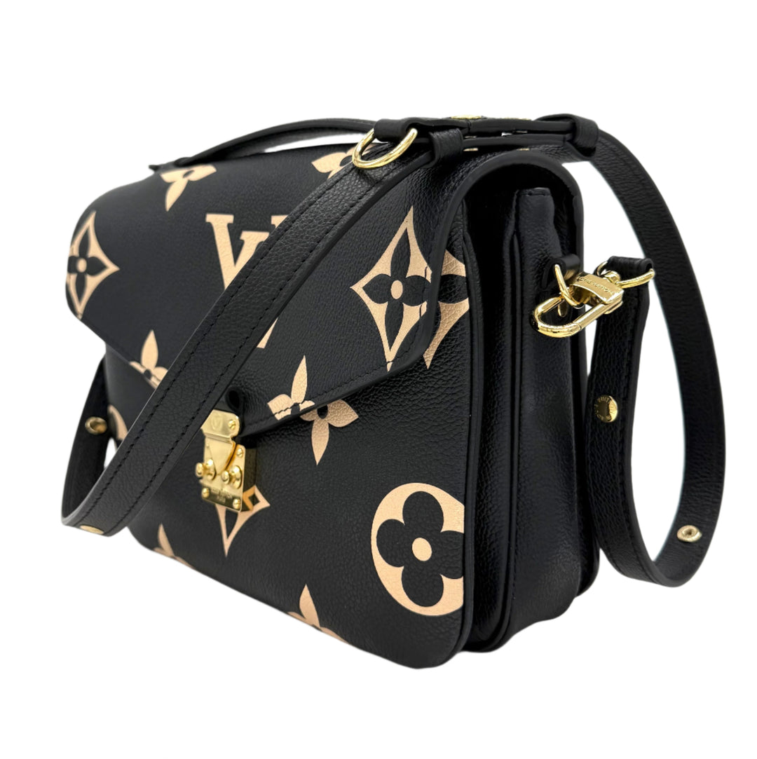 Authentic Louis Vuitton Empreinte Monogram Giant Pochette Metis in black and beige, featuring oversized monogram design and crossbody strap.