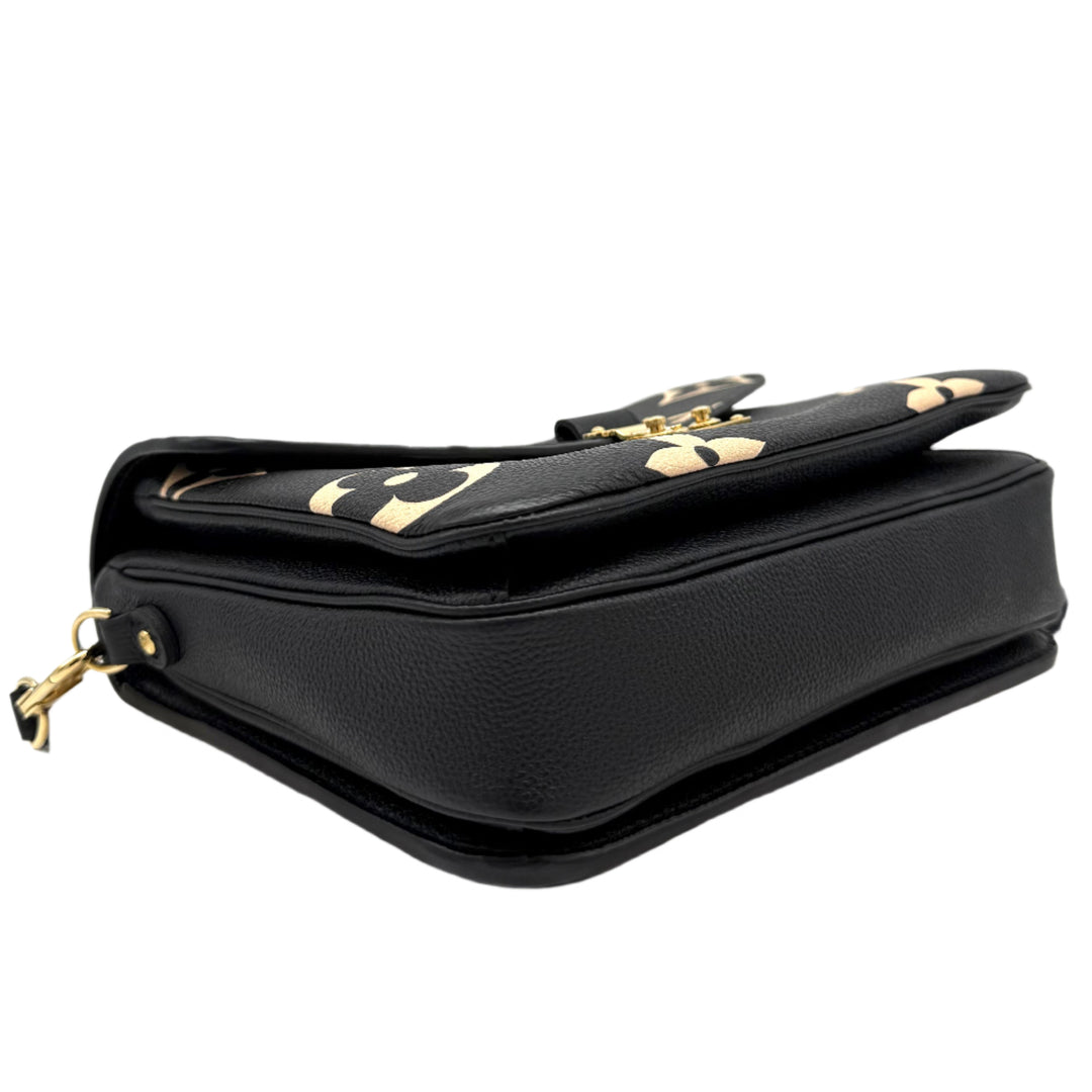 Authentic Louis Vuitton Empreinte Monogram Giant Pochette Metis in Black and Beige, showcasing its sleek side profile and gold accents.