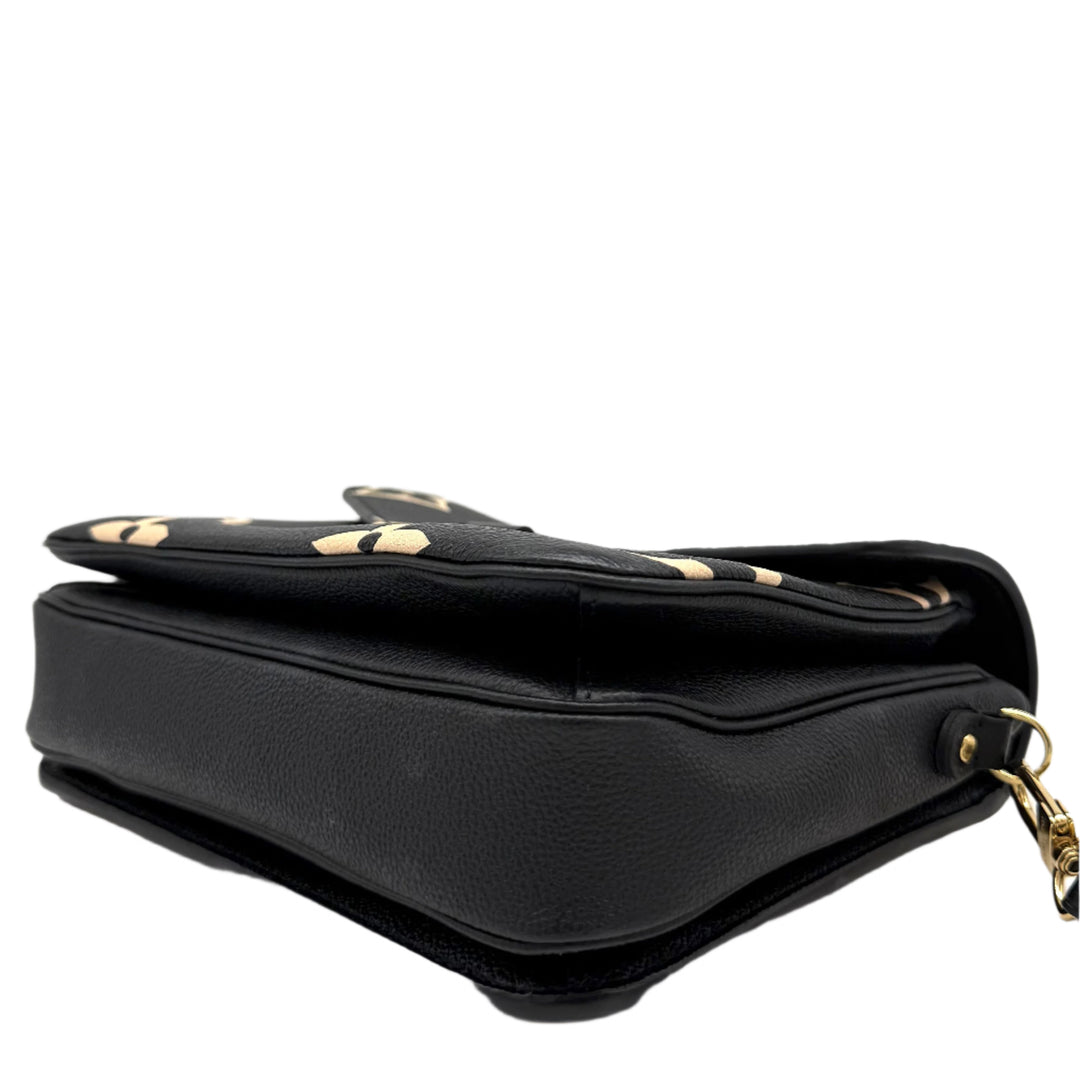 Side view of Authentic Louis Vuitton Empreinte Monogram Giant Pochette Metis in Black and Beige showcasing its elegant design.