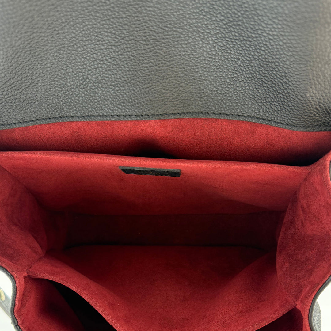 Interior view of the Authentic Louis Vuitton Empreinte Monogram Giant Pochette Metis showing red suede lining and compartments.