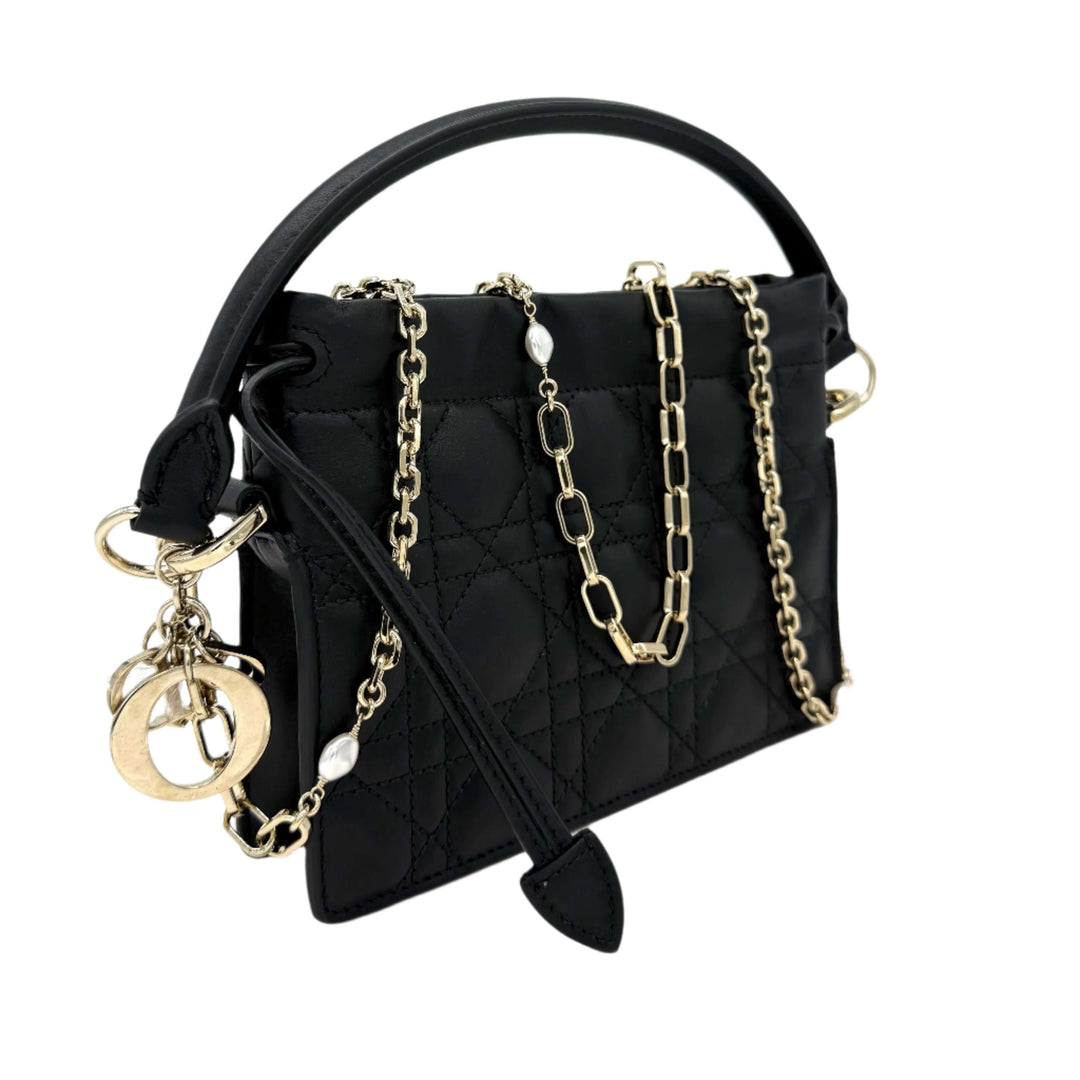 Authentic Christian Dior black lambskin mini top handle drawstring bag with gold chain and iconic charm.