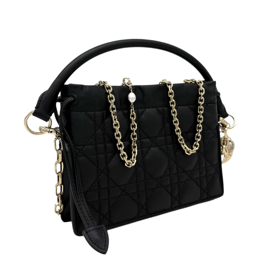 Authentic Christian Dior black lambskin mini top handle drawstring bag with Cannage quilted design and gold chain accents.