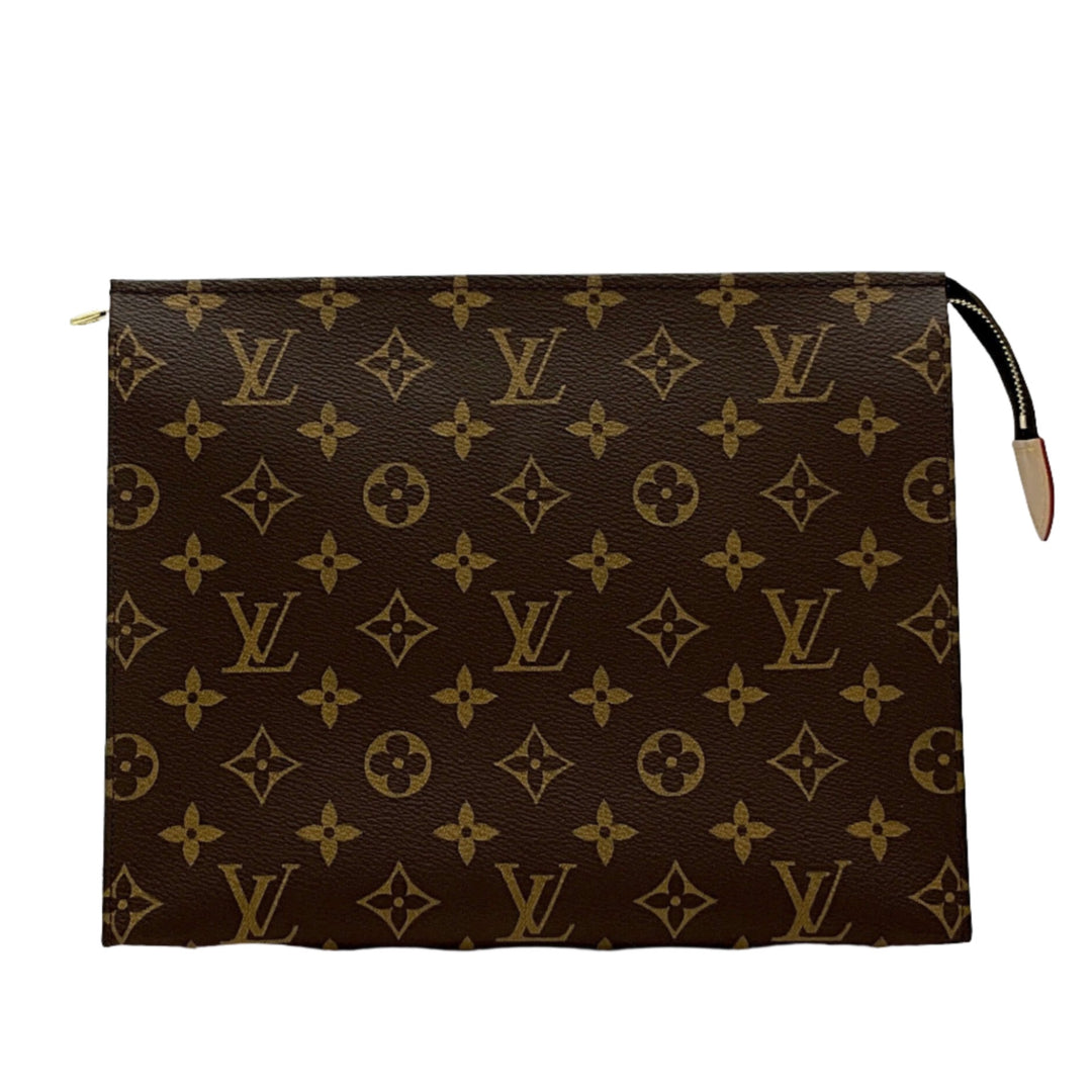 Louis Vuitton Monogram Toiletry Pouch 26 with classic LV logos and brown leather background.