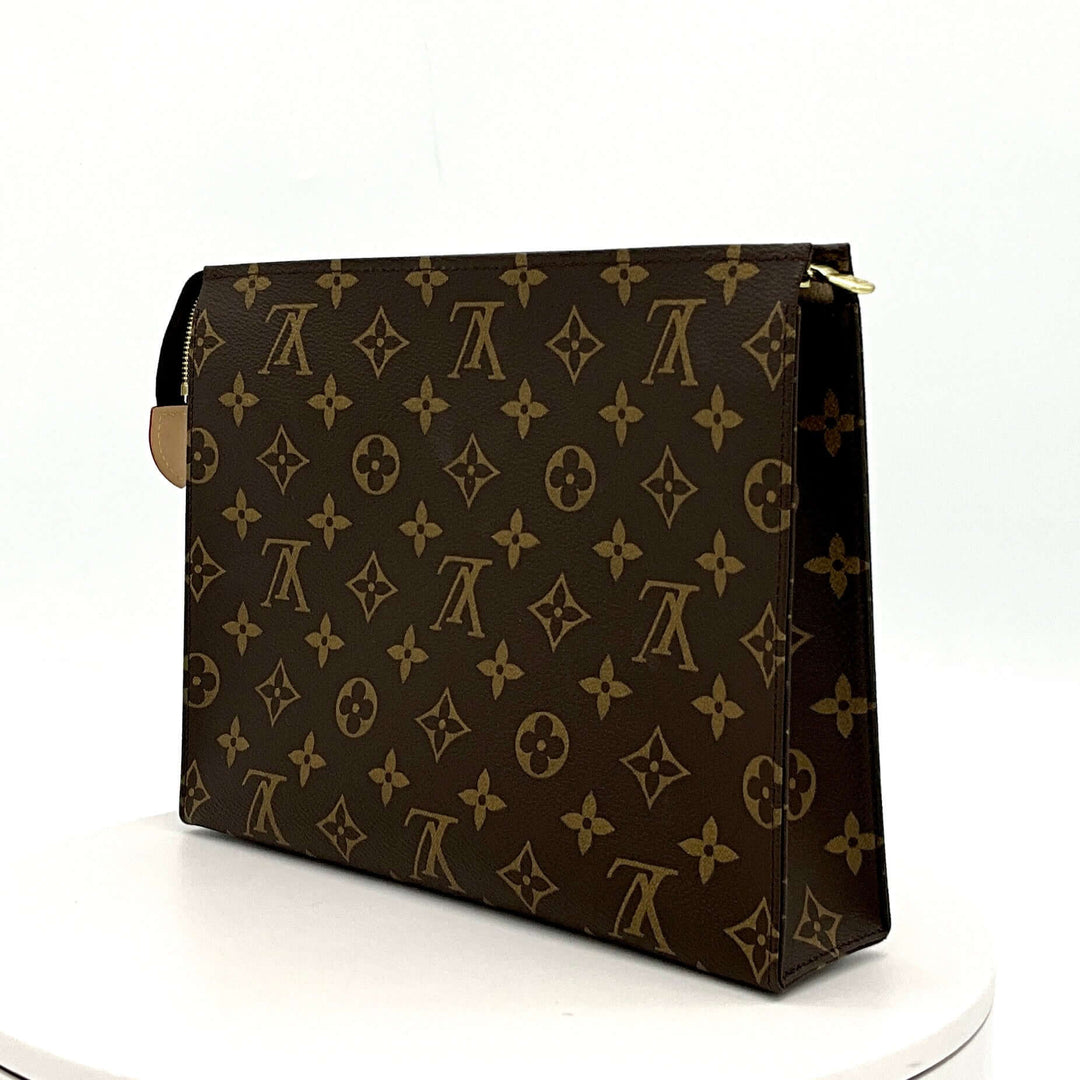 Louis Vuitton Monogram Toiletry Pouch 26 on white background showcasing versatile and timeless design.