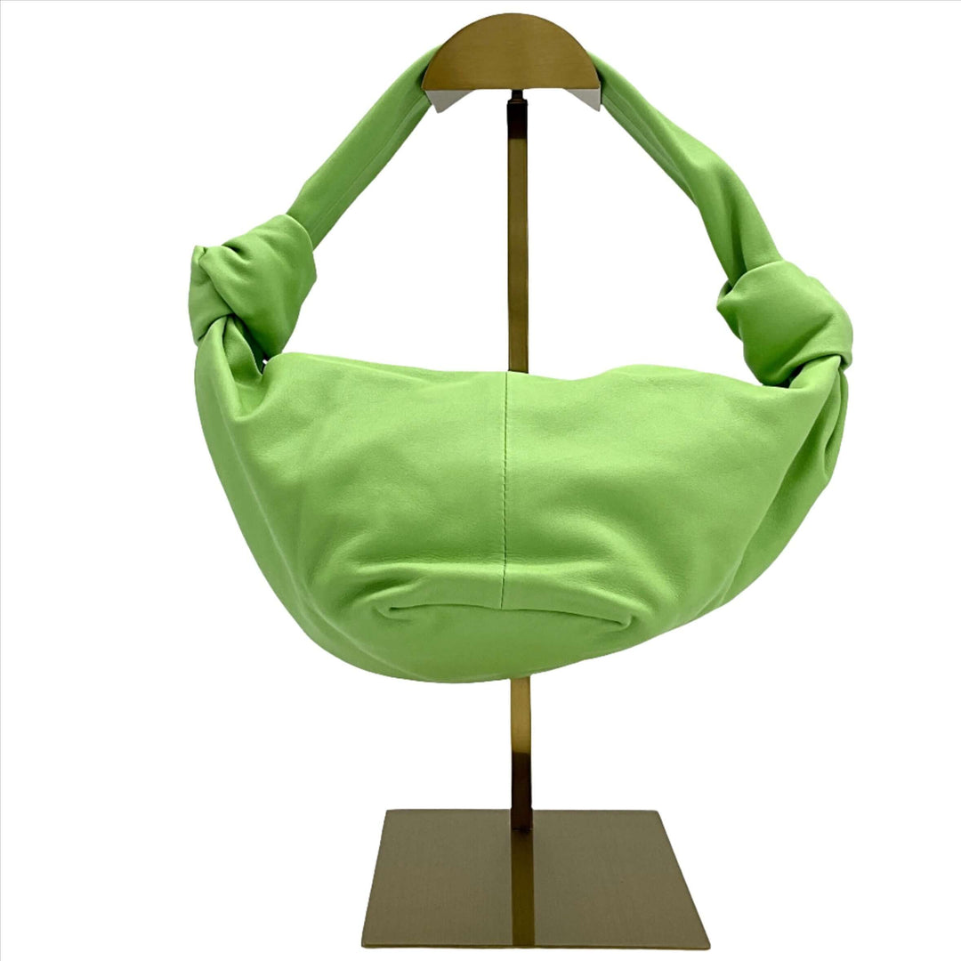 BOTTEGA VENETA Nappa Mini Double Knot Bag in green displayed on a stand.