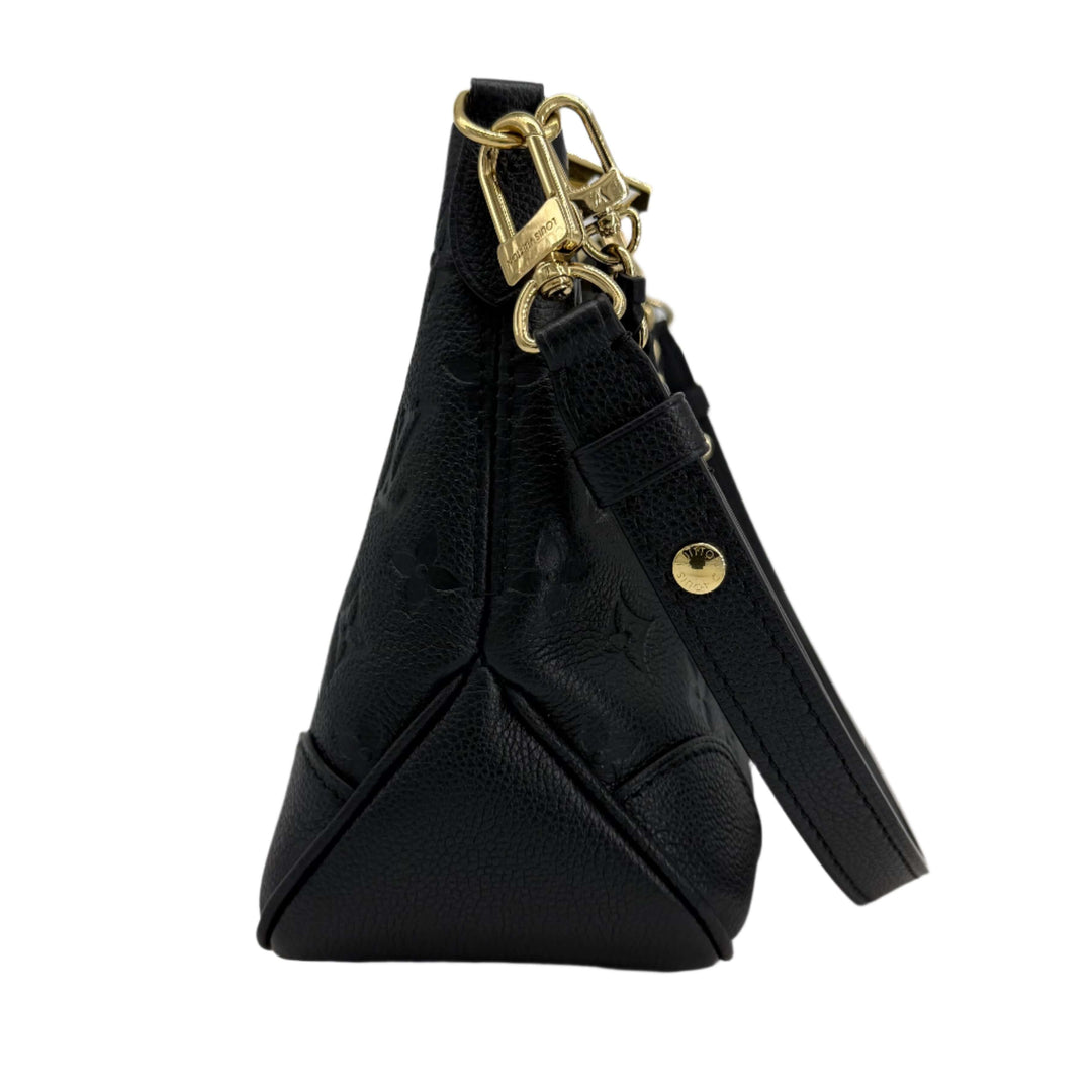 Side view of Louis Vuitton Boulogne Bag in black Monogram Empreinte leather, showcasing gold hardware and sleek design.