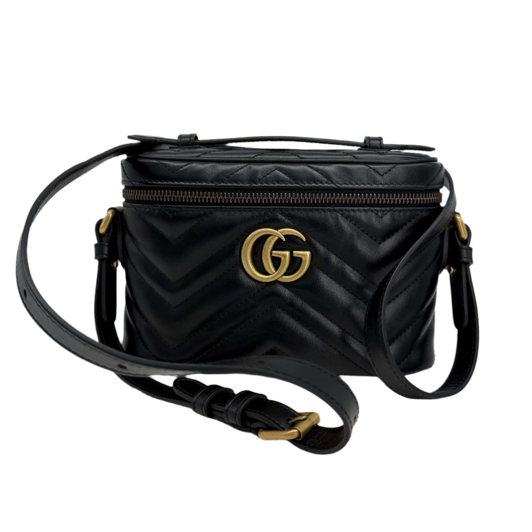 Gucci Mini GG Marmont Round Backpack in black calfskin with gold GG logo and adjustable strap, authentic pre-owned.