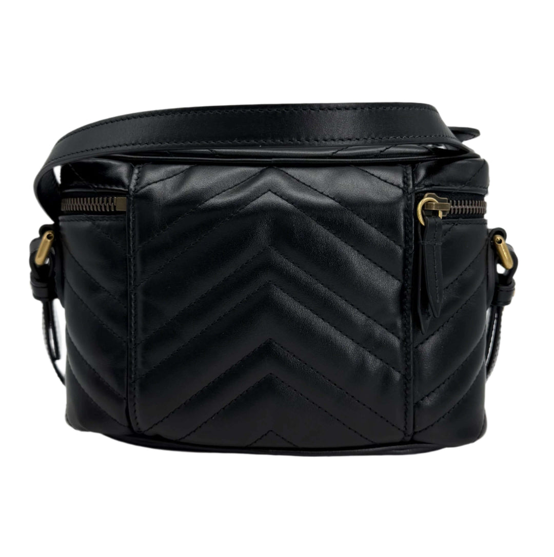 Gucci Mini GG Marmont Round Backpack in black calfskin, featuring chevron quilted design and aged gold hardware.