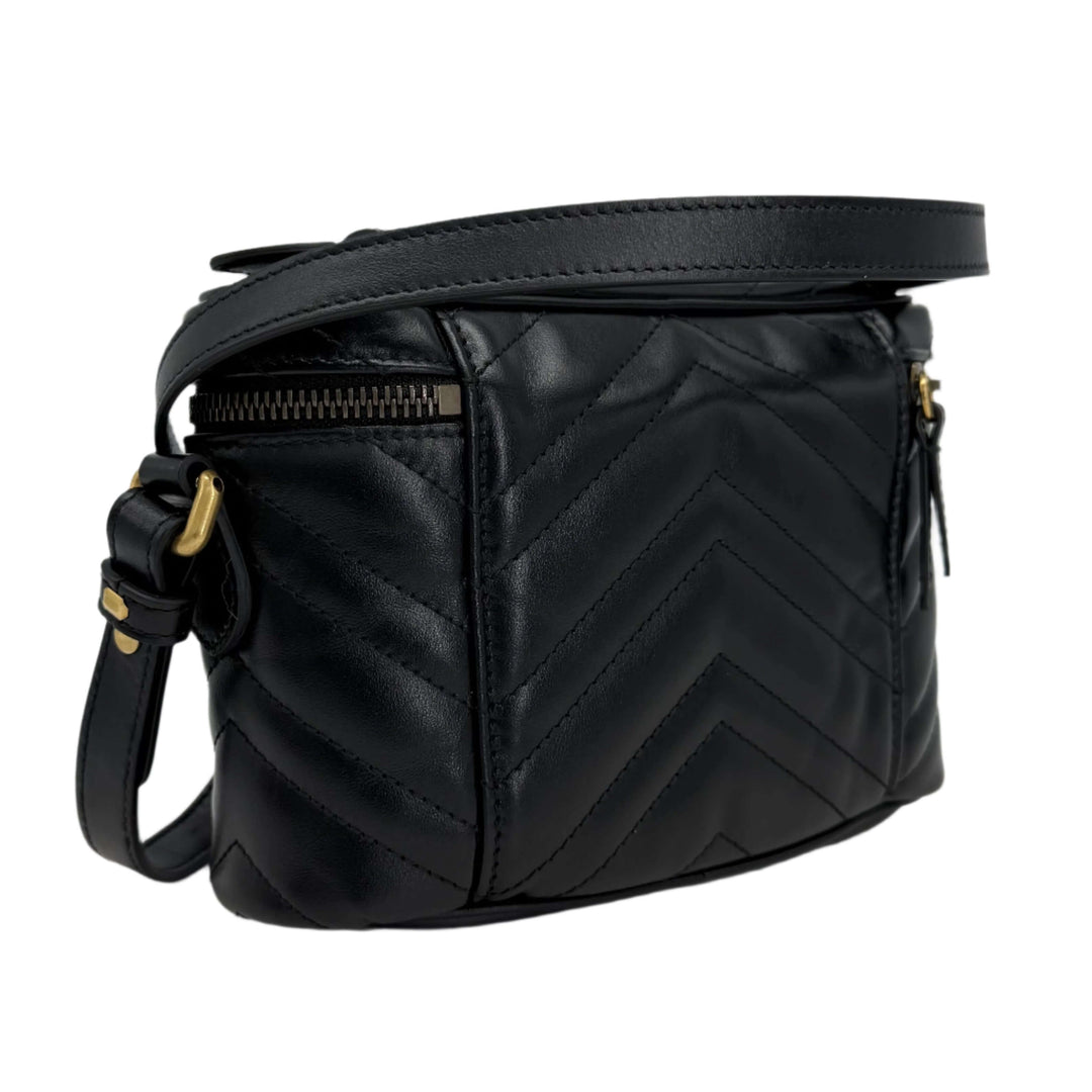 Gucci Calfskin Matelassé Mini GG Marmont Round Backpack in black with chevron quilt design and adjustable strap.