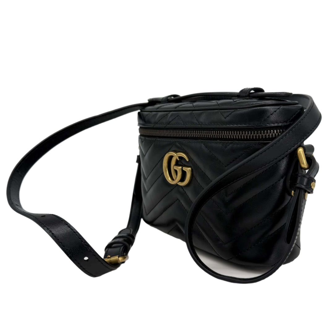 Gucci Mini GG Marmont Round Backpack in black calfskin leather with gold hardware and adjustable strap.