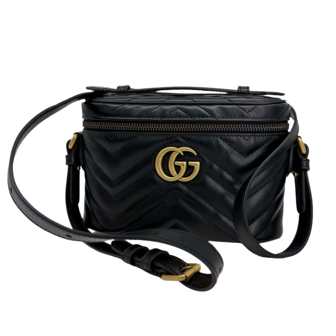 Gucci Calfskin Matelassé Mini GG Marmont Round Backpack in black with gold hardware.