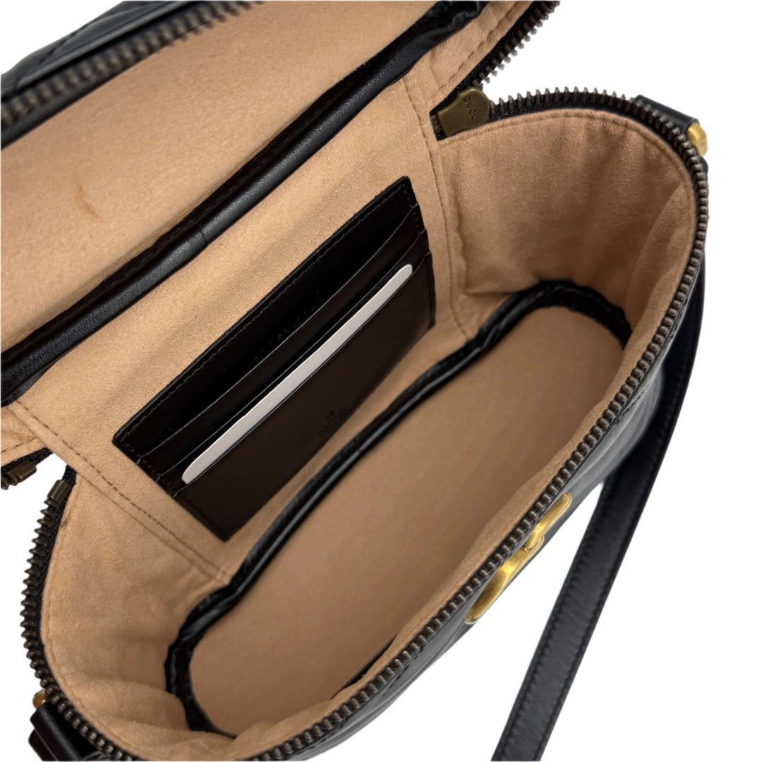 Interior view of Gucci Mini GG Marmont Round Backpack showing card slots and spacious compartment.