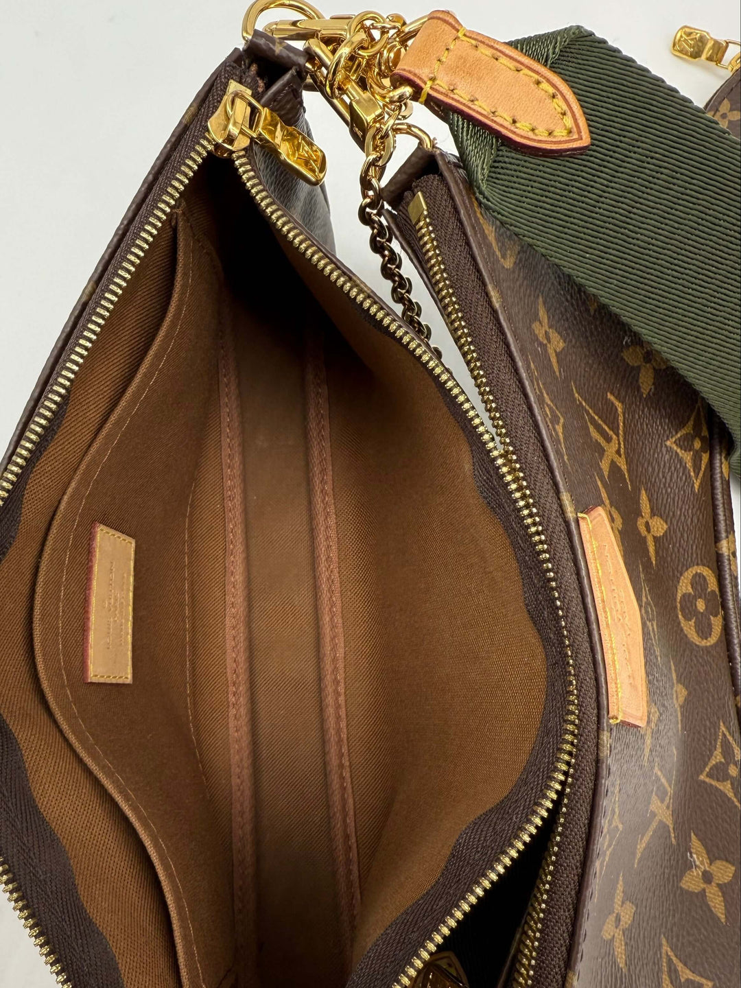 Interior view of Louis Vuitton Monogram Multi Pochette Accessoires in Khaki, featuring multiple compartments and premium lining.