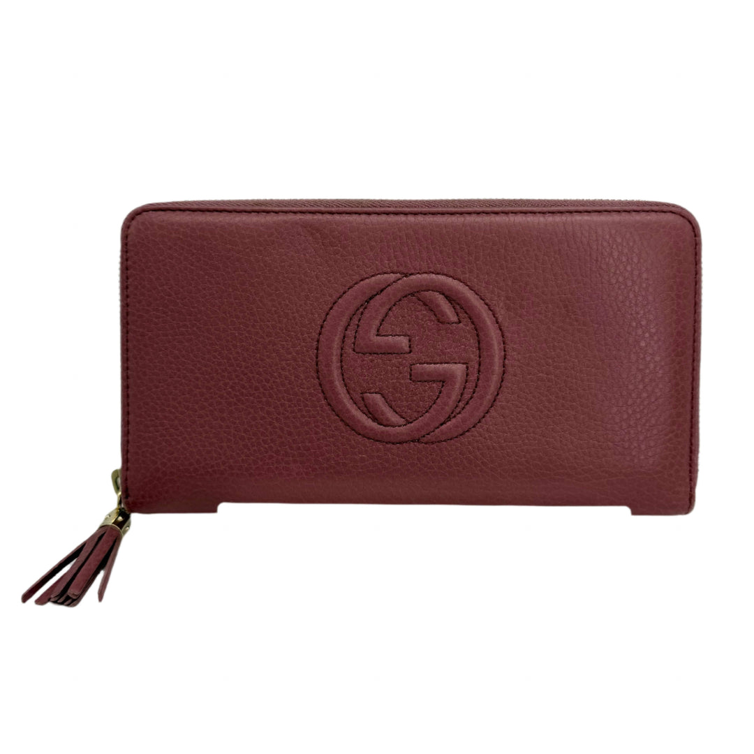 Gucci Zippy Leather Wallet in mauve pink with zip-around closure and iconic logo, authentic pre-owned accessory.