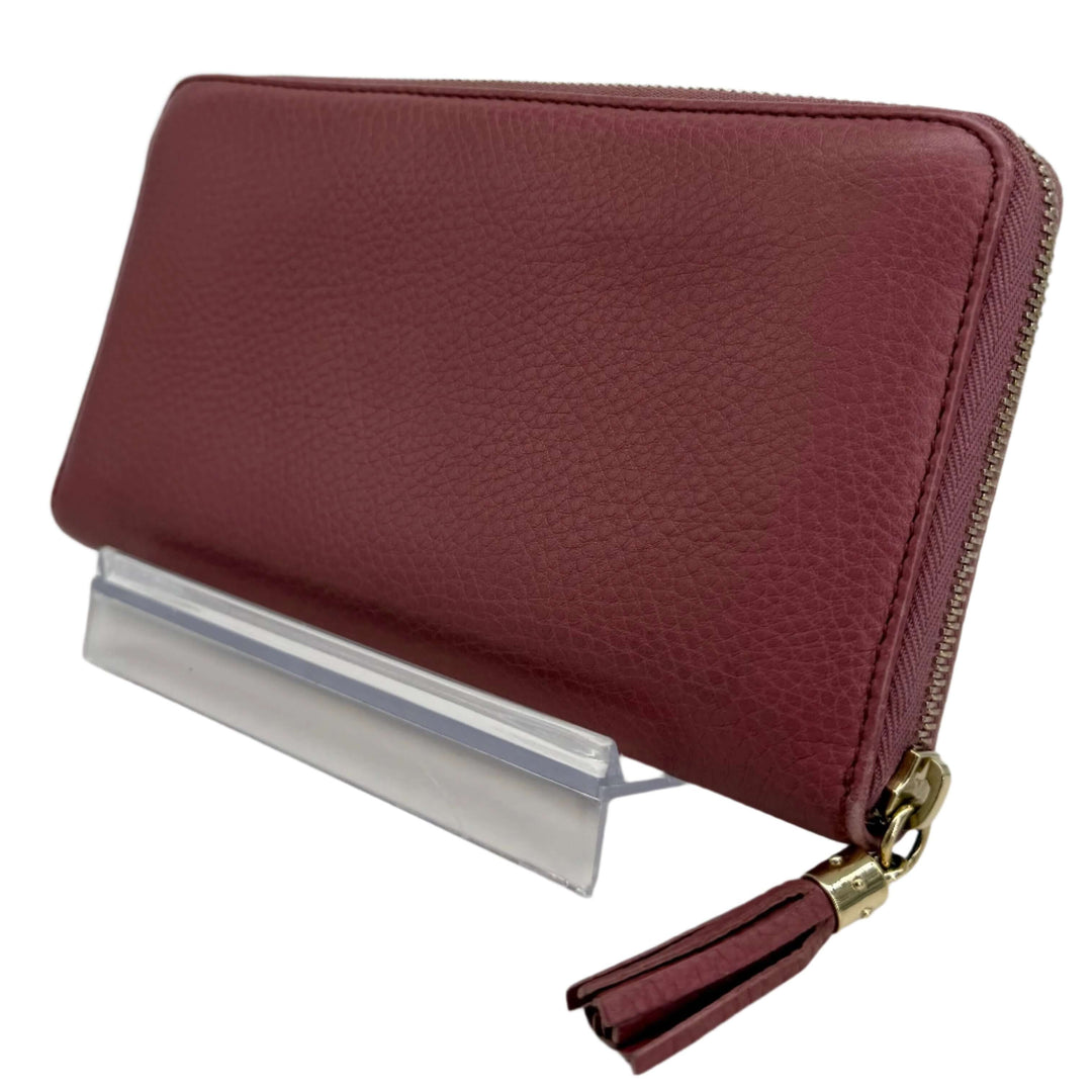 Gucci Zippy Leather Wallet in mauve pink, showcasing luxurious texture and stylish zip-around closure.