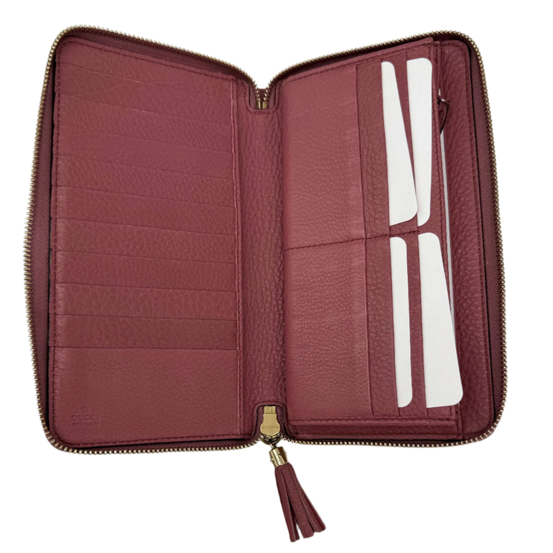 Interior view of authentic Gucci Zippy Leather Wallet in mauve pink with multiple card slots and zip closure.