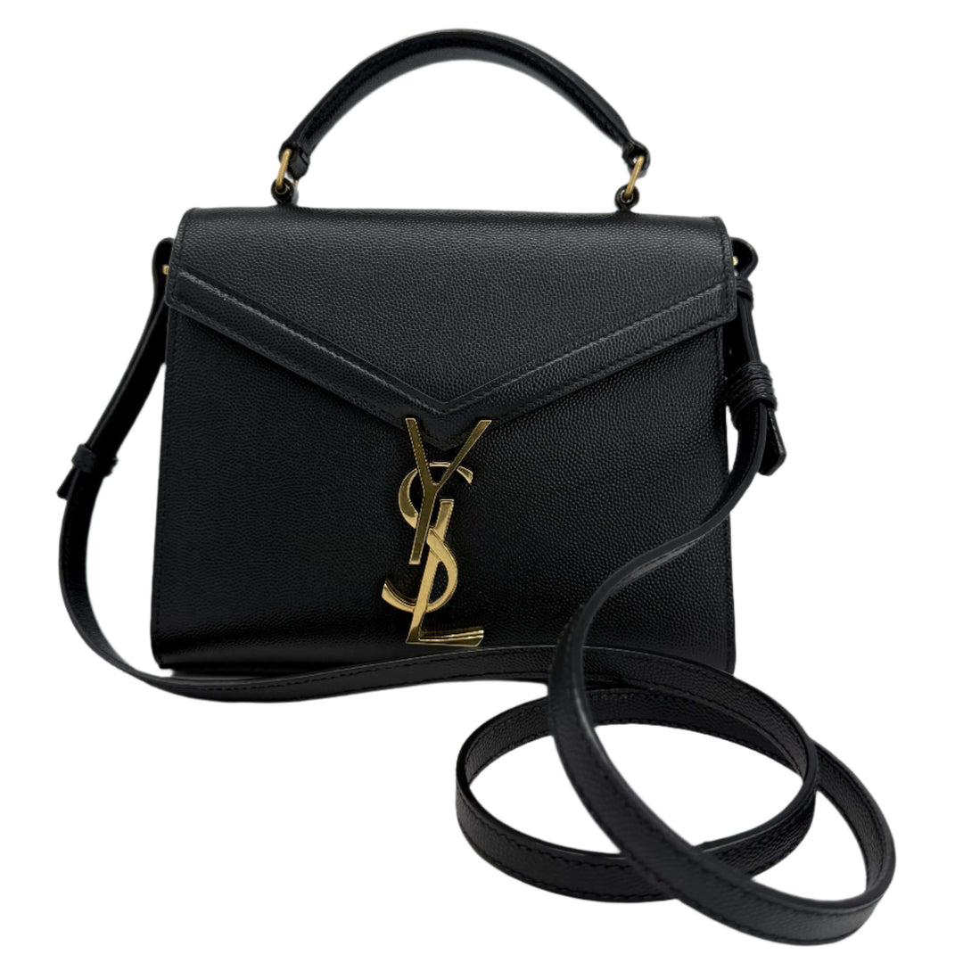 Saint Laurent Grain de Poudre Mini Classic Monogram Cassandra Top Handle Bag in black leather with gold hardware.