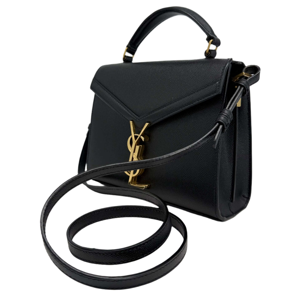 Saint Laurent Grain de Poudre Mini Cassandra Top Handle Bag in black with gold YSL logo and strap.