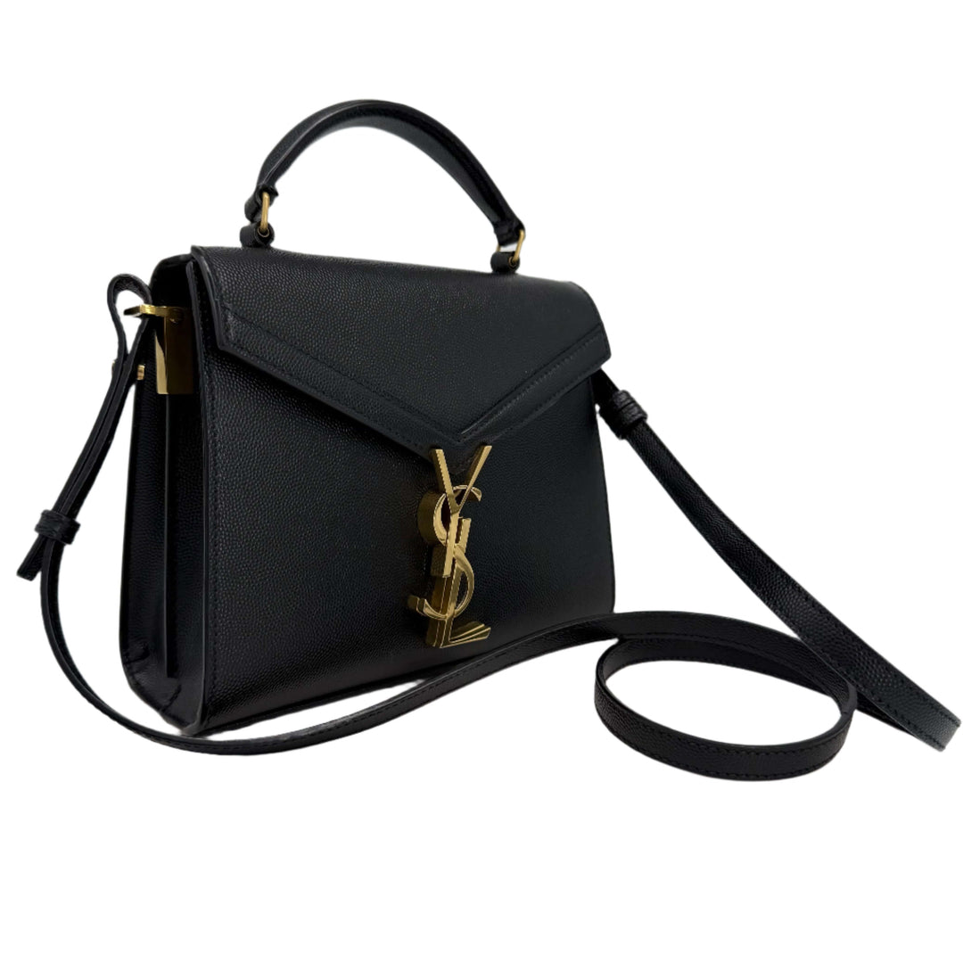 Saint Laurent Grain de Poudre Mini Monogram Cassandra Top Handle Bag in black with gold YSL hardware.