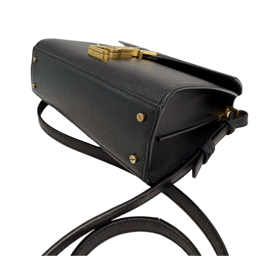 Saint Laurent grain de poudre mini classic Cassandra top handle bag in black leather with aged gold hardware.