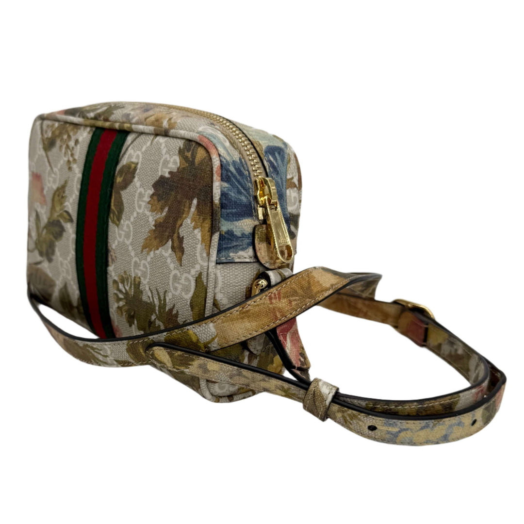 Gucci floral print crossbody bag with green and red stripe, featuring a zip closure and adjustable strap.