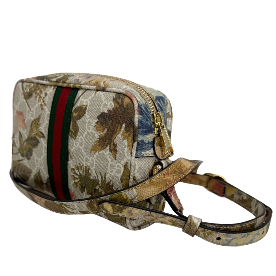 Gucci floral print crossbody bag featuring monogram canvas and iconic green-red stripes.