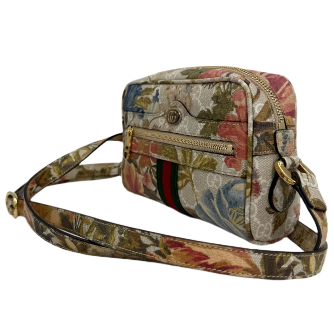 Stylish Gucci floral print handbag with zippered pocket, gold accents, and adjustable strap.