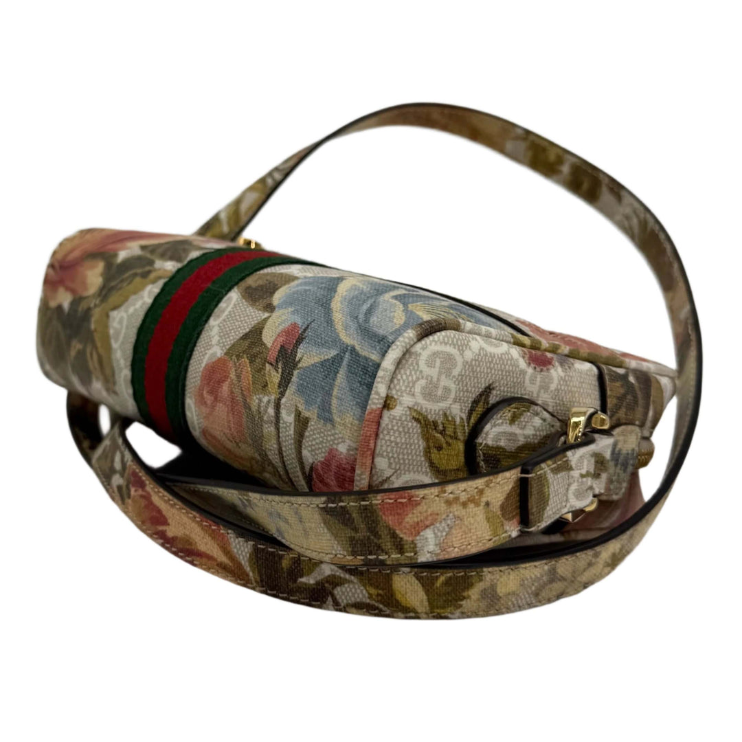 Gucci floral print shoulder bag with green and red stripe detail, showcasing modern luxury and style.