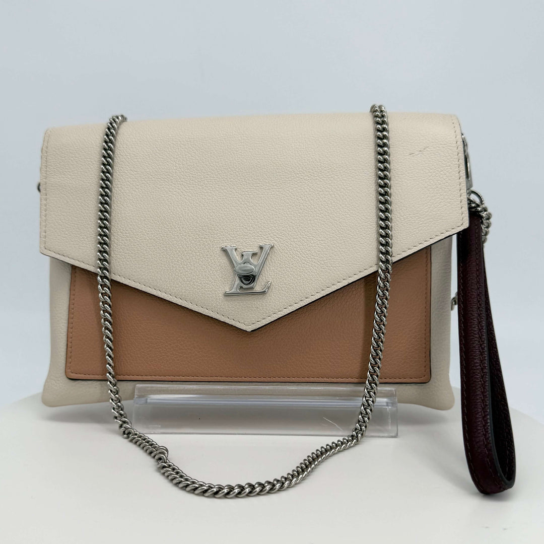 Authentic Louis Vuitton Soft Calfskin My Lockme Pochette in cream and tan with silver-tone chain strap.